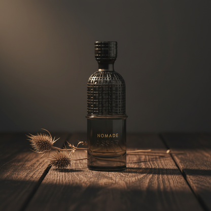 Nomade Assaf EDP – lifestyle shot with dried botanical stems leaning left at base, Arabian luxury mood