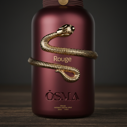 Close-up detail of Rouge by OSMA gold snake sculpture on burgundy bottle
