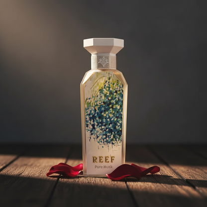 Reef Pure Musk perfume bottle styled with rose petals on dark wood, Arabian luxury mood